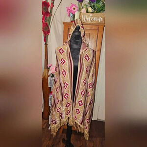 A Papaya Fashion poncho with hood. One size fits all.